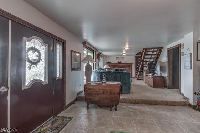 382 E Mohawk Dr, Malvern, OH 44644 - foyer entrance featuring carpet floors, tile patterned flooring, stairway, a fireplace, and baseboards