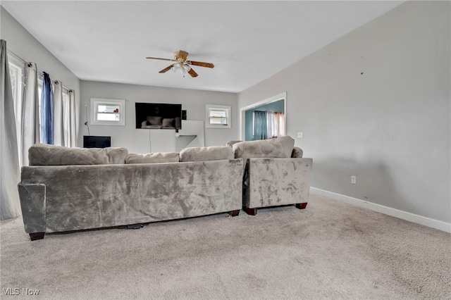 living room featuring carpet, a ceiling fan, and baseboards