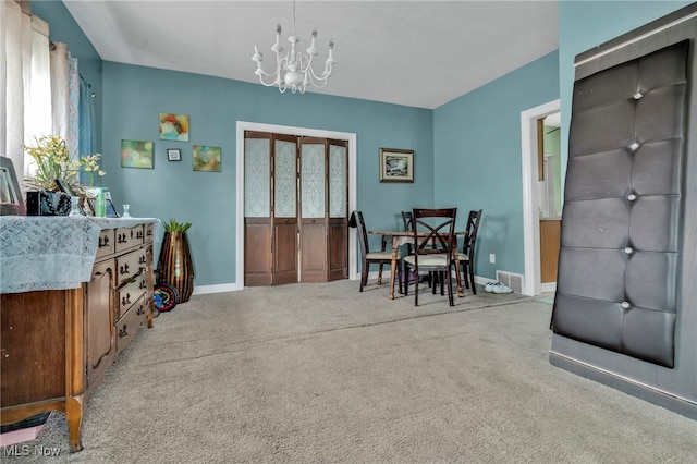 dining area with carpet, visible vents, baseboards, and a notable chandelier