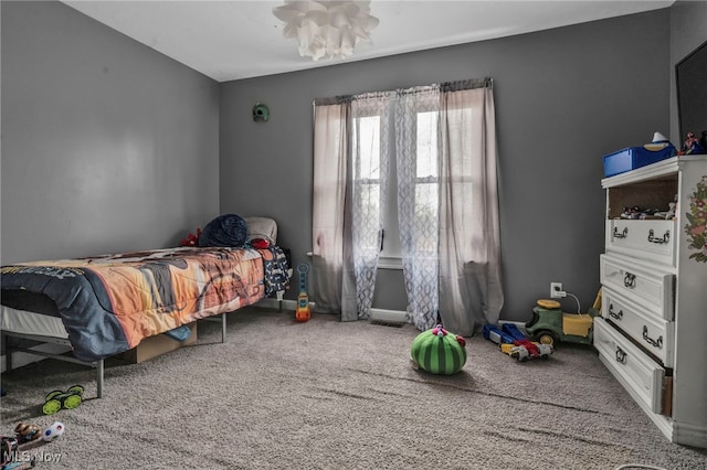 bedroom featuring carpet and baseboards