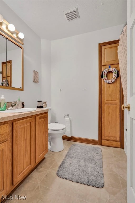 full bathroom with baseboards, visible vents, toilet, tile patterned floors, and vanity