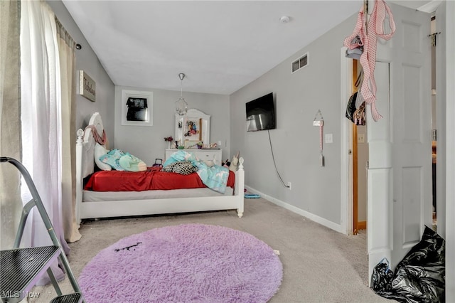 carpeted bedroom with visible vents and baseboards