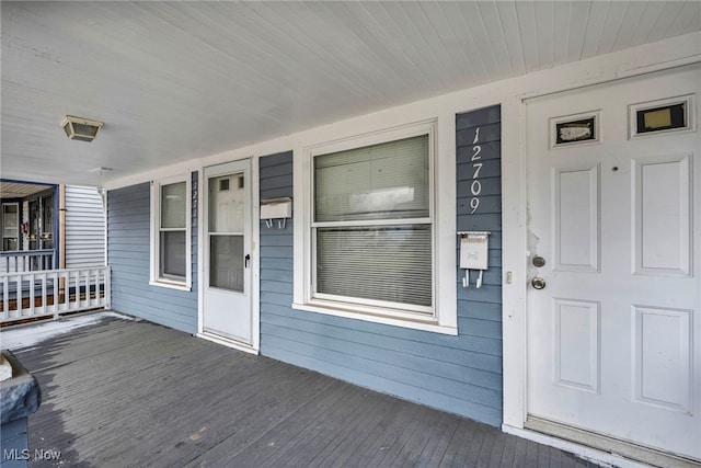 view of exterior entry with a porch