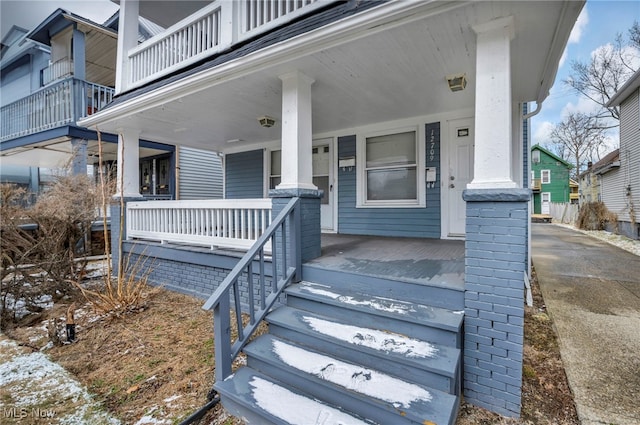 view of exterior entry with a porch