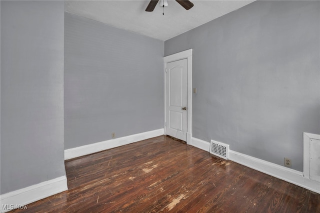 spare room with hardwood / wood-style flooring, baseboards, visible vents, and ceiling fan