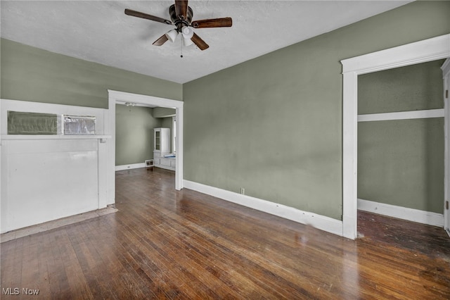 empty room with a ceiling fan, baseboards, and hardwood / wood-style flooring