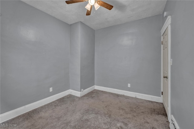 carpeted empty room with ceiling fan, a textured ceiling, and baseboards