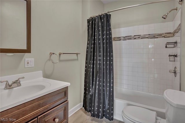 bathroom with toilet, shower / bath combo, wood finished floors, and vanity