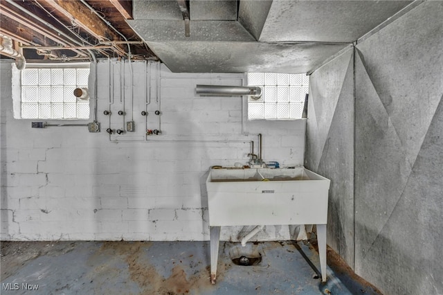 basement featuring plenty of natural light and a sink