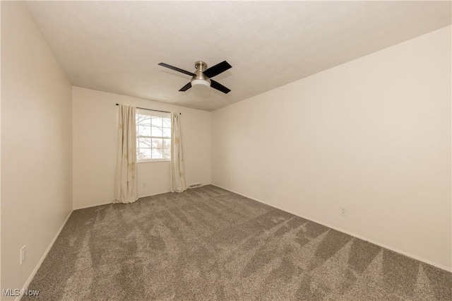 unfurnished room featuring ceiling fan and carpet flooring