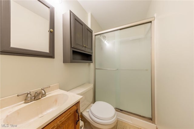 bathroom featuring a stall shower, vanity, and toilet