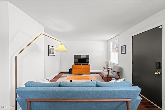 living room featuring baseboards and wood finished floors