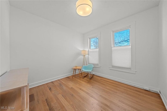 unfurnished room featuring wood finished floors and baseboards