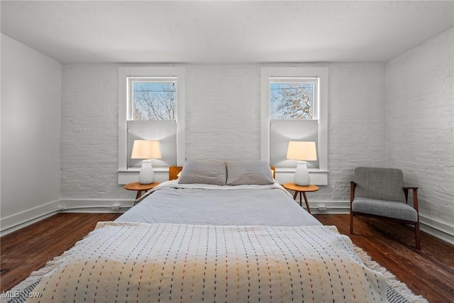 bedroom with baseboards and wood finished floors