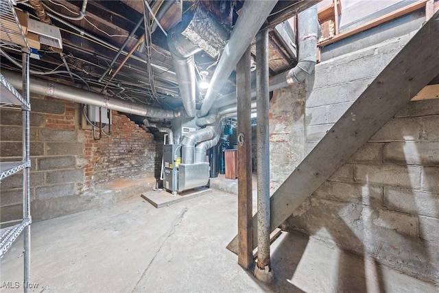 unfinished basement featuring heating unit