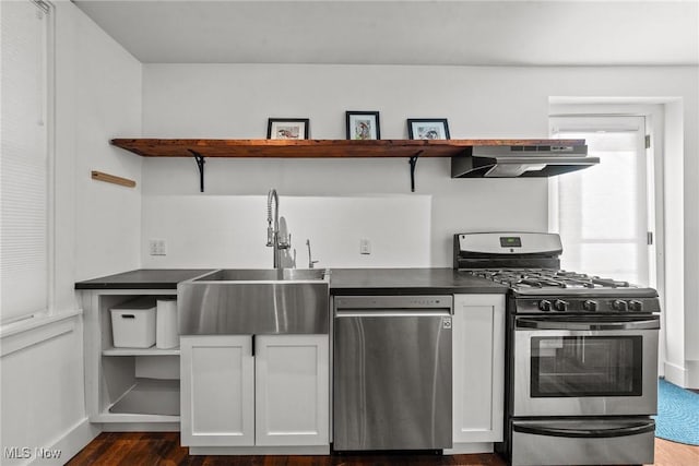 kitchen with open shelves, appliances with stainless steel finishes, dark countertops, and under cabinet range hood