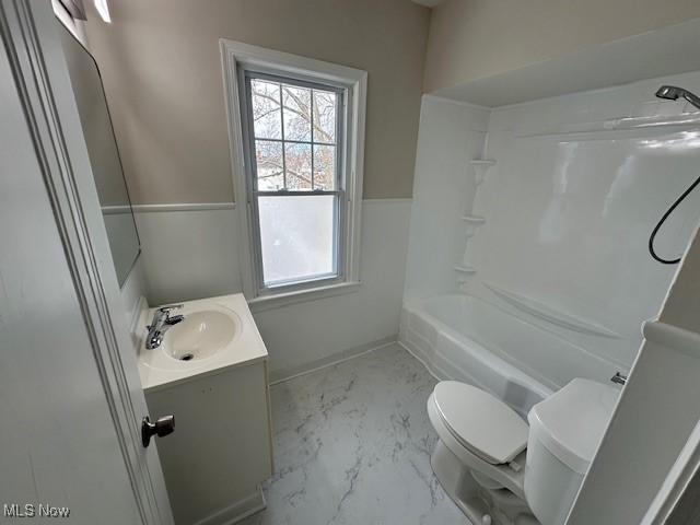 full bath with marble finish floor, vanity, toilet, and bathtub / shower combination