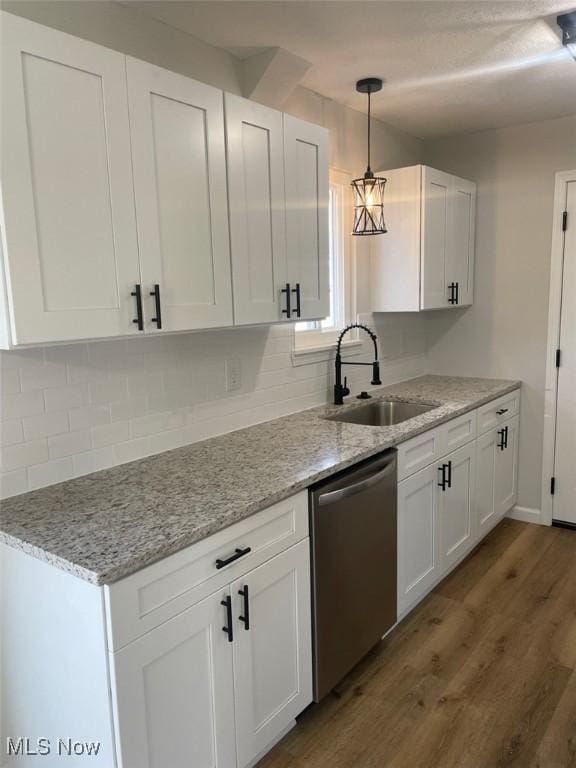 kitchen featuring white cabinets, a sink, and stainless steel dishwasher