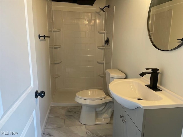 full bathroom with marble finish floor, tiled shower, vanity, and toilet