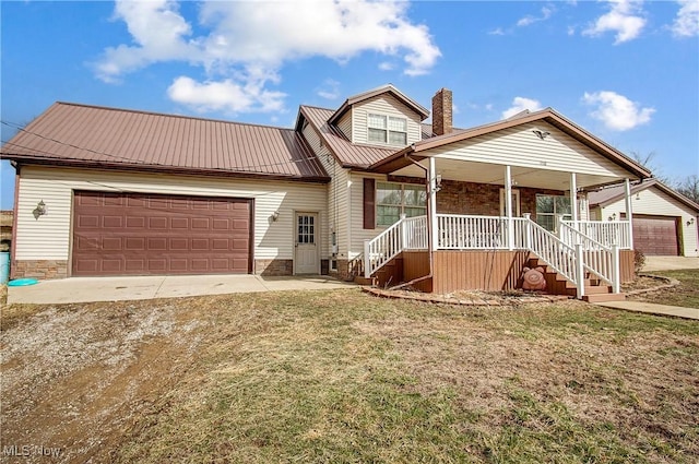 view of front of home featuring metal roof, an attached garage, covered porch, driveway, and a chimney