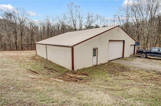 detached garage with a wooded view