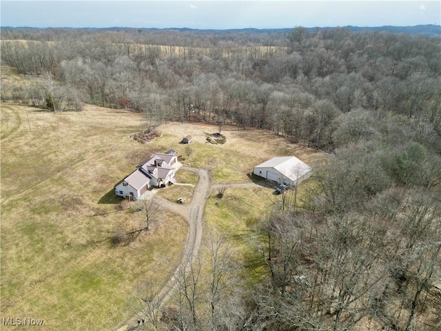 aerial view featuring a wooded view and a rural view