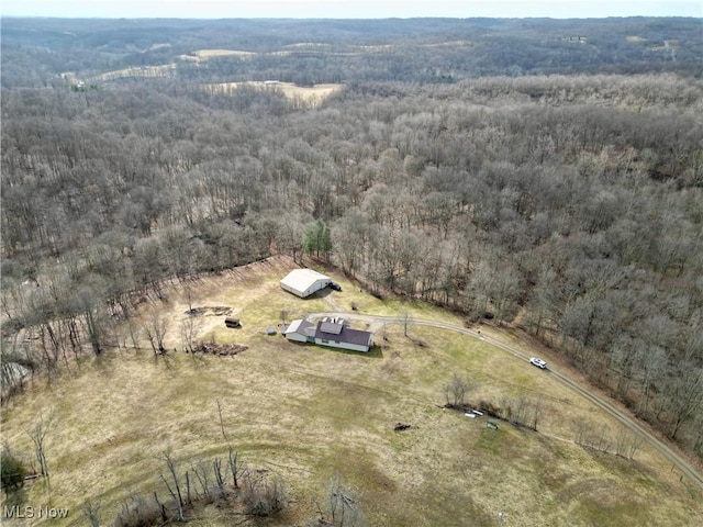 aerial view featuring a view of trees and a rural view