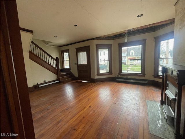 entryway with hardwood / wood-style flooring, baseboards, and stairway