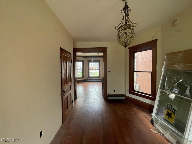 hall featuring dark wood finished floors and baseboards