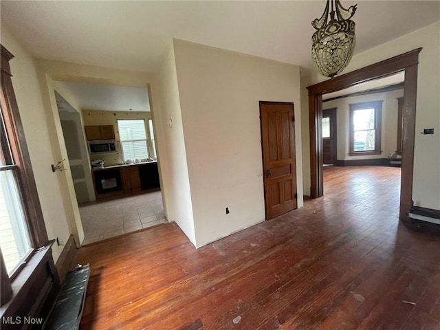 213 Montgomery, Marietta, OH 45750 - empty room with hardwood / wood-style floors and a chandelier