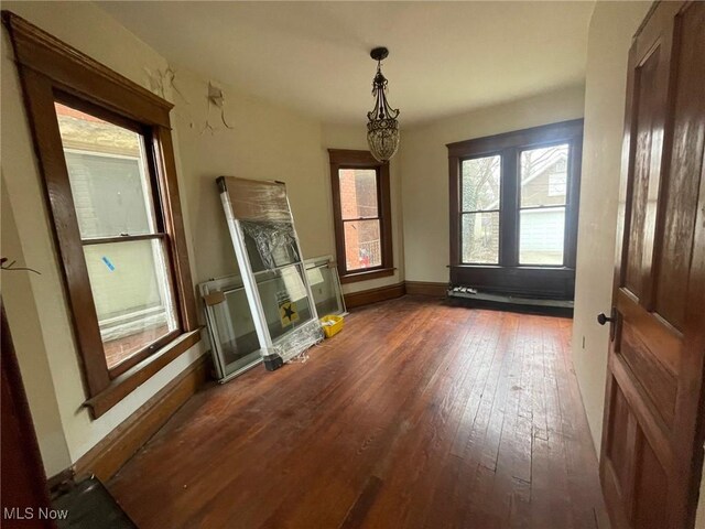213 Montgomery, Marietta, OH 45750 - unfurnished dining area featuring hardwood / wood-style floors and a chandelier