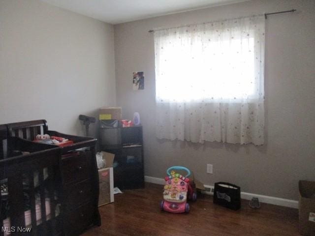 bedroom featuring baseboards and wood finished floors