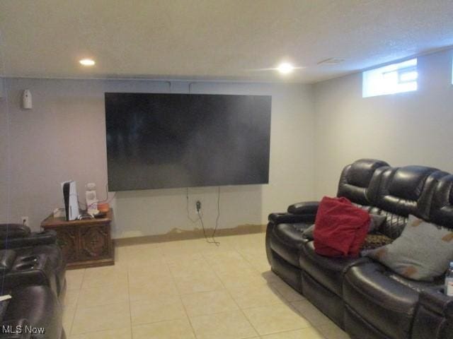 home theater room featuring light tile patterned floors