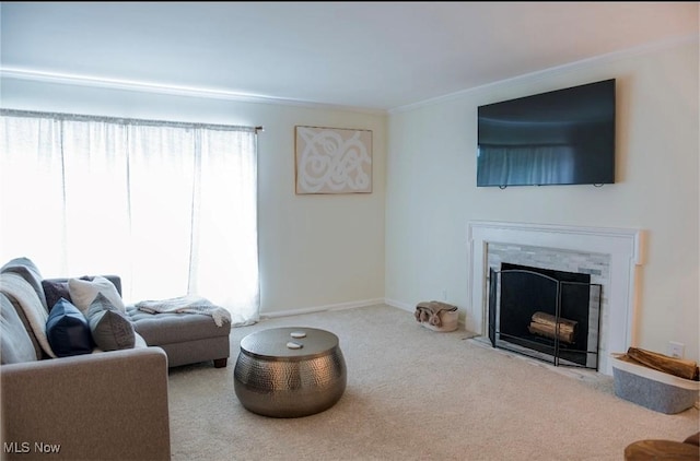 carpeted living room featuring baseboards, a premium fireplace, and crown molding