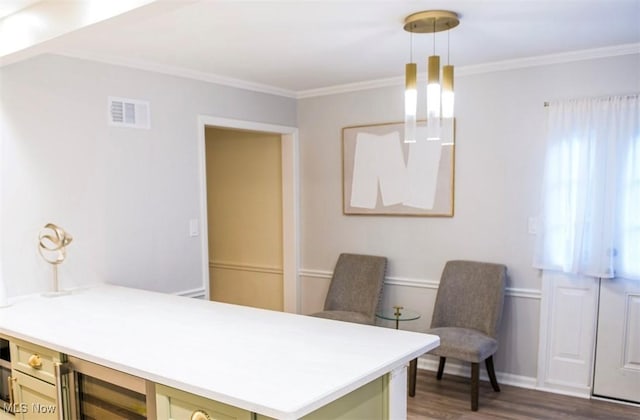 office area with wine cooler, visible vents, crown molding, and wood finished floors