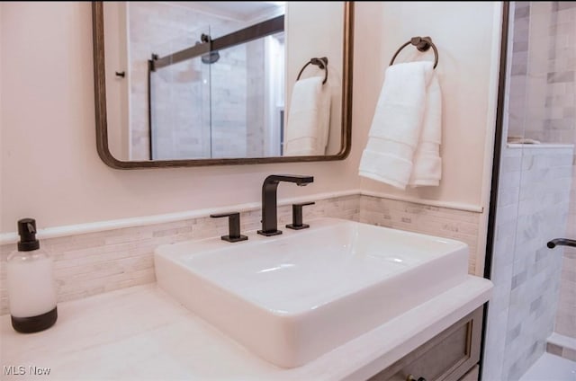 bathroom featuring tile walls, a wainscoted wall, and a shower stall