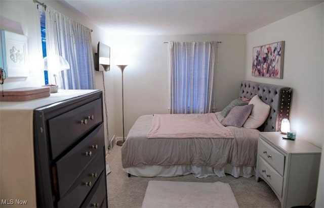 bedroom featuring light carpet