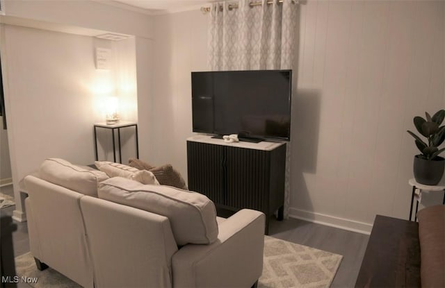 living room featuring baseboards and dark wood finished floors