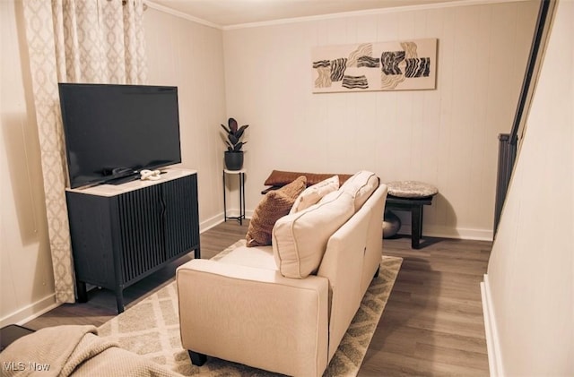 living area with ornamental molding, baseboards, and wood finished floors