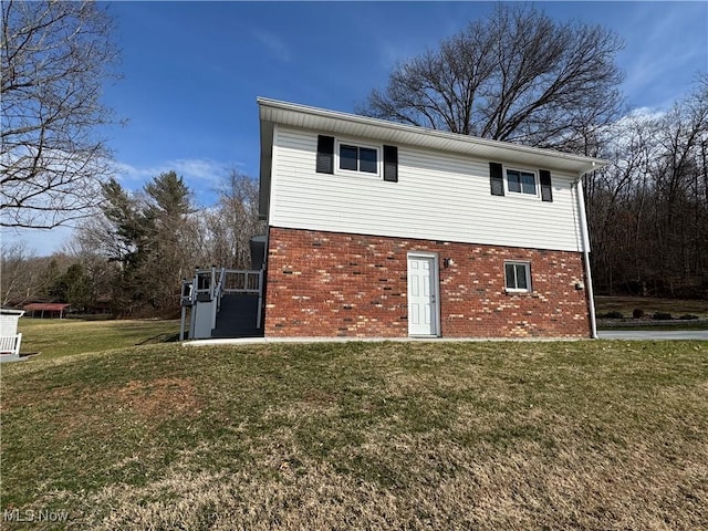 exterior space featuring brick siding and a lawn