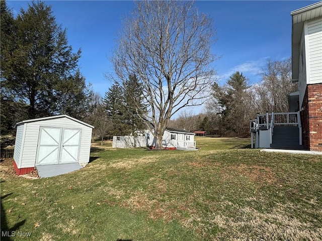 view of yard with a storage shed and an outdoor structure