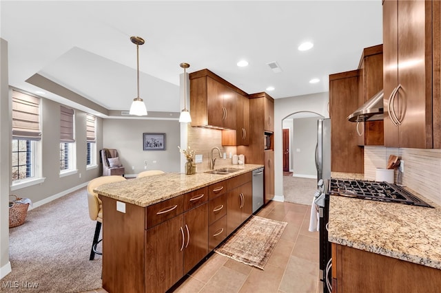 kitchen with visible vents, extractor fan, arched walkways, stainless steel appliances, and a sink