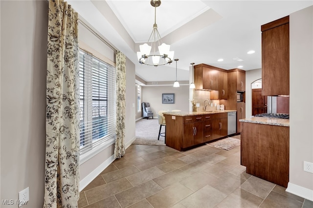 kitchen featuring a sink, an inviting chandelier, a raised ceiling, dishwasher, and light stone countertops