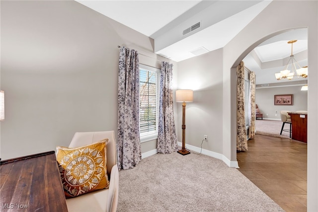 sitting room featuring visible vents, baseboards, carpet flooring, an inviting chandelier, and arched walkways