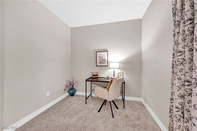 carpeted home office with baseboards