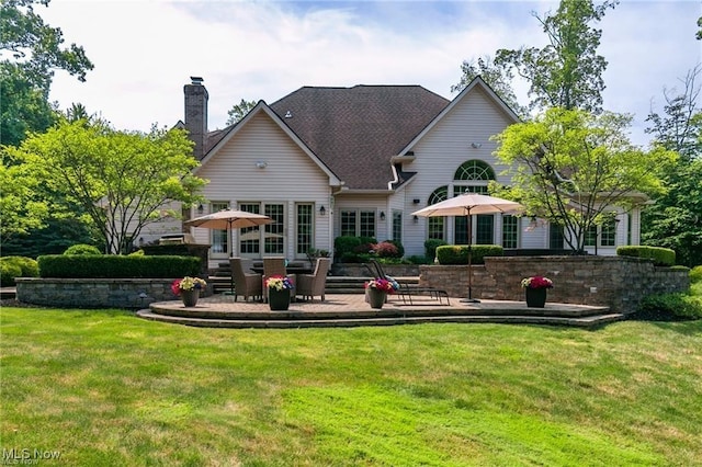 back of house featuring a yard and a patio