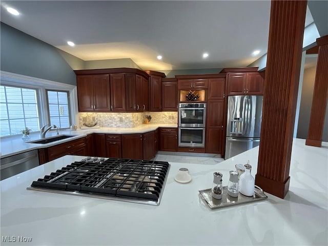 kitchen featuring recessed lighting, a sink, light countertops, appliances with stainless steel finishes, and tasteful backsplash