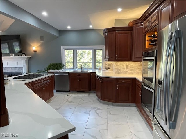 kitchen featuring decorative backsplash, appliances with stainless steel finishes, marble finish floor, light countertops, and a sink