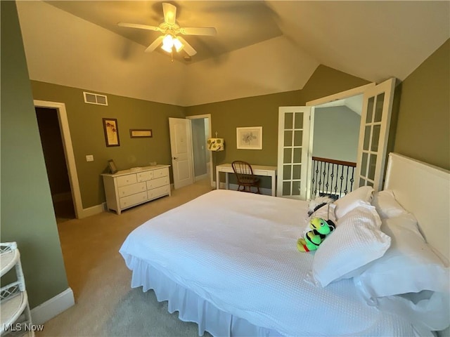 bedroom featuring carpet floors, lofted ceiling, visible vents, a ceiling fan, and baseboards