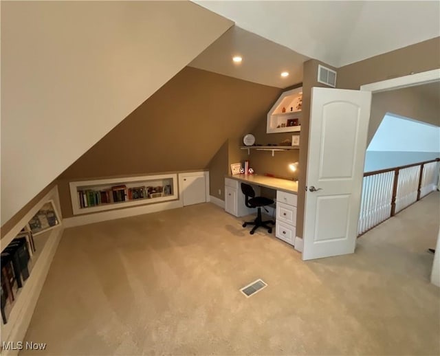 unfurnished office featuring recessed lighting, visible vents, vaulted ceiling, and light colored carpet